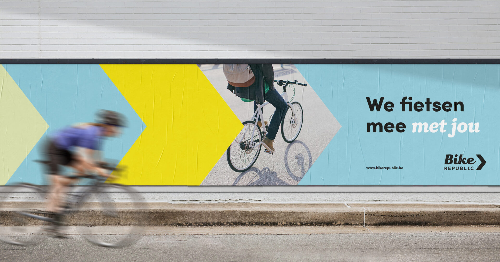 Horizontal posters in the streets with a bicycle and a baseline, serving as a marketing campaign.